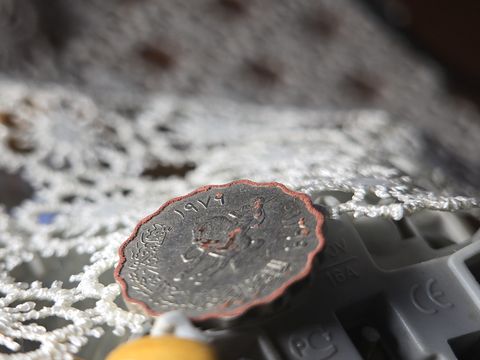 Frame 11: the lace just behind the coin is sharp